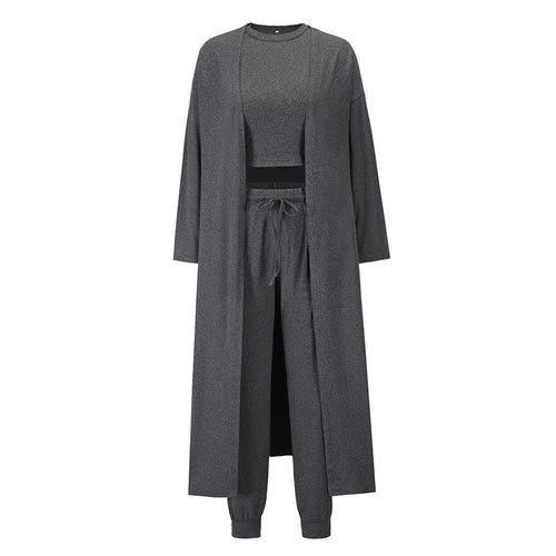 This three-piece set for women features a knitted cardigan with a sleeveless shirt and long pants. A sophisticated and comfortable sports suit ensemble.