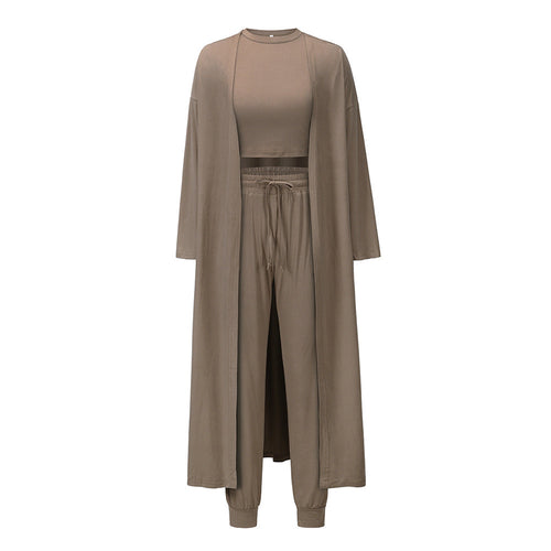 This three-piece set for women features a knitted cardigan with a sleeveless shirt and long pants. A sophisticated and comfortable sports suit ensemble.